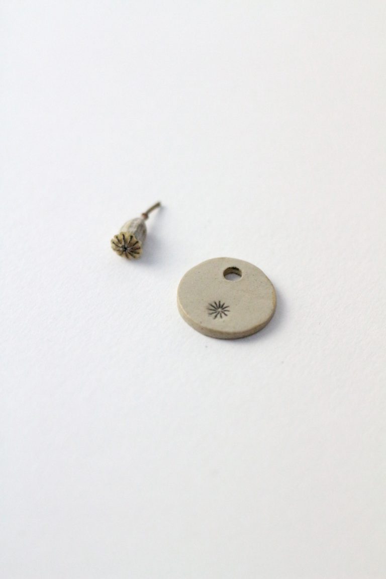 poppy capsule and ceramic earring hanger with poppy stamp