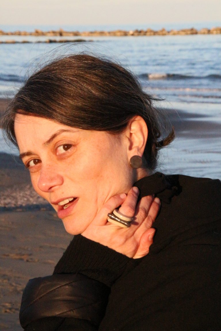 woman wearing ceramic earring and ring