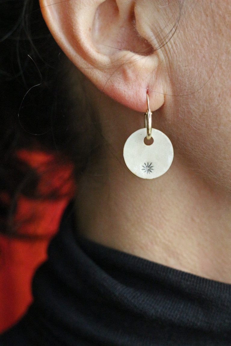 woman's ear wearing poppy earring hanger