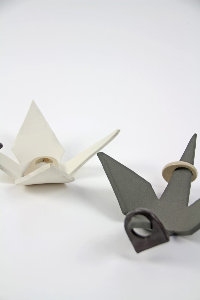 ceramic cranes with rings on top