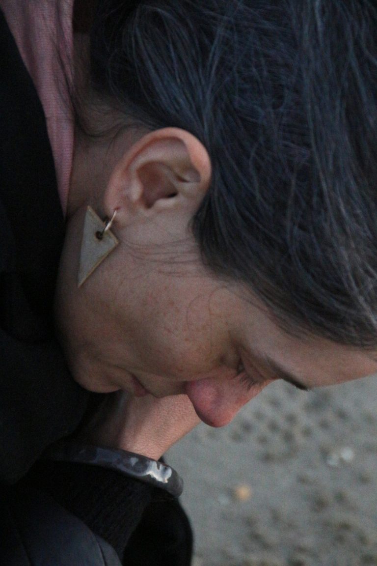 woman wearing ceramic earring hanger