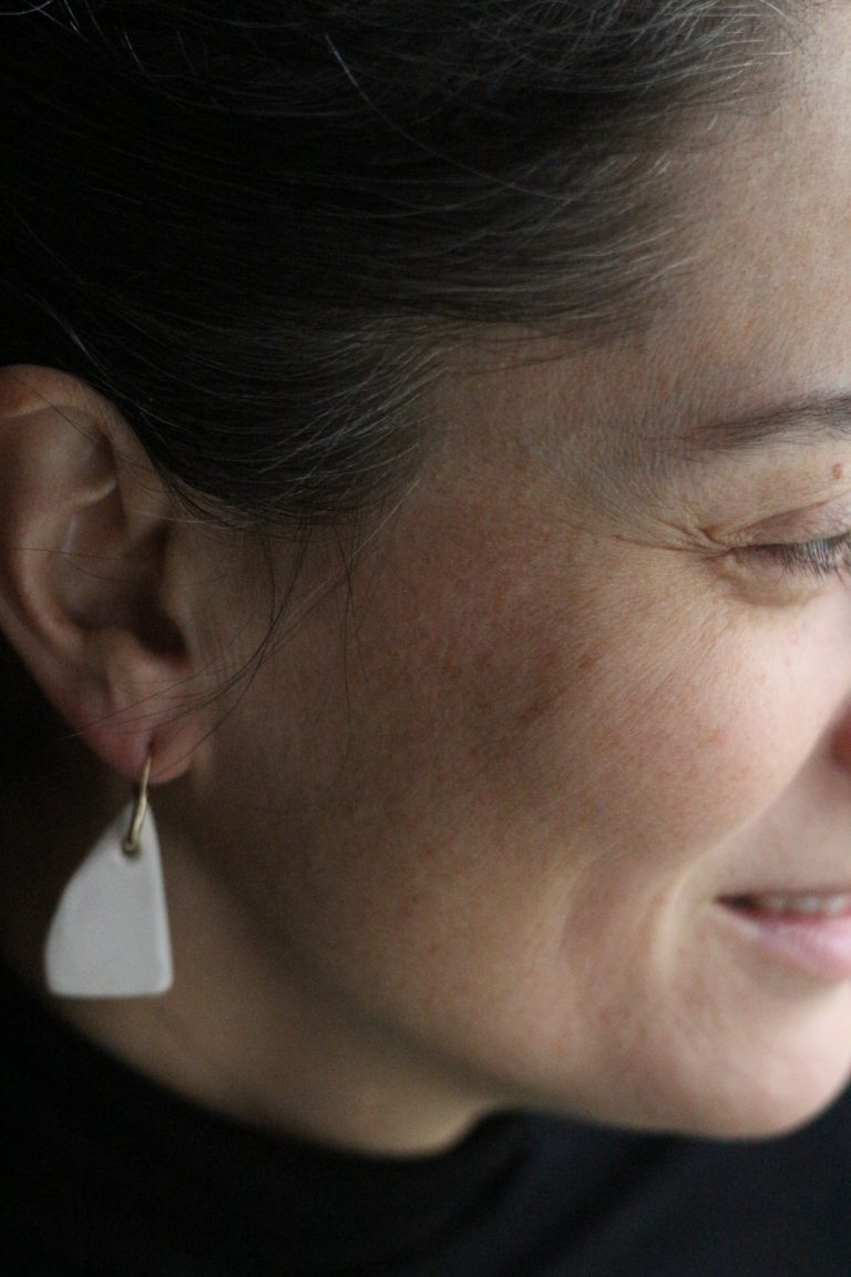 woman wearing ceramic earring hanger