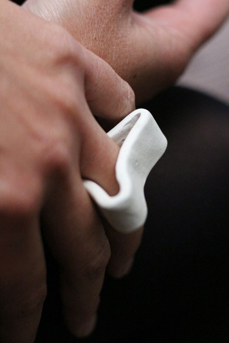hand wearing white ceramic ring