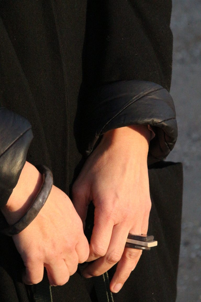 arm wearing ceramic bracelet and rings
