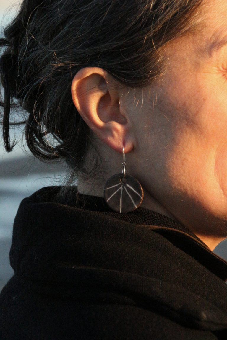 woman wearing ceramic earring