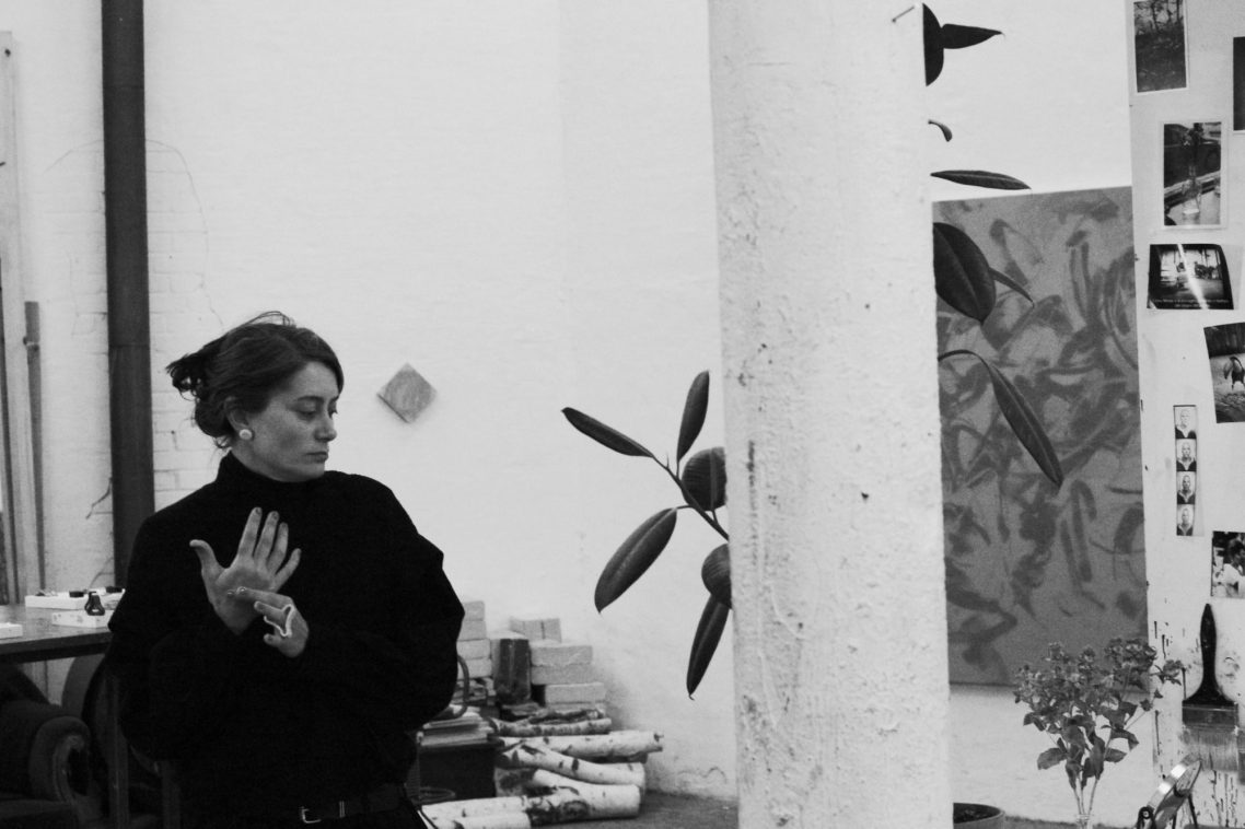 woman in an atelier, looking on the side