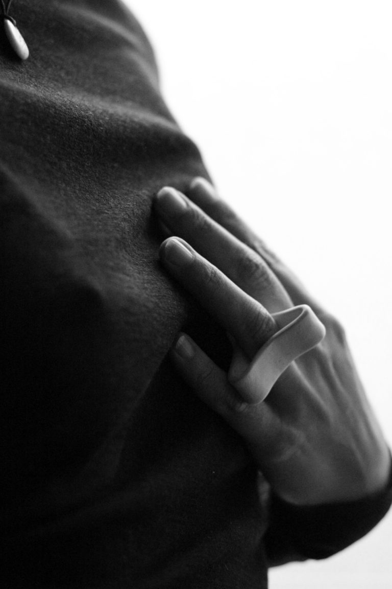 hand wearing white ceramic ring
