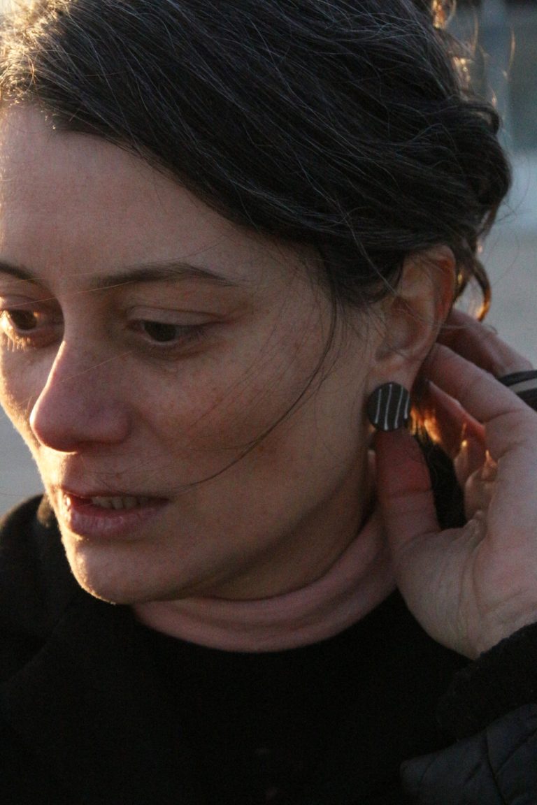 woman wearing ceramic earring